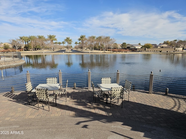 dock area featuring a water view and a patio area