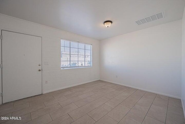 unfurnished room with light tile floors