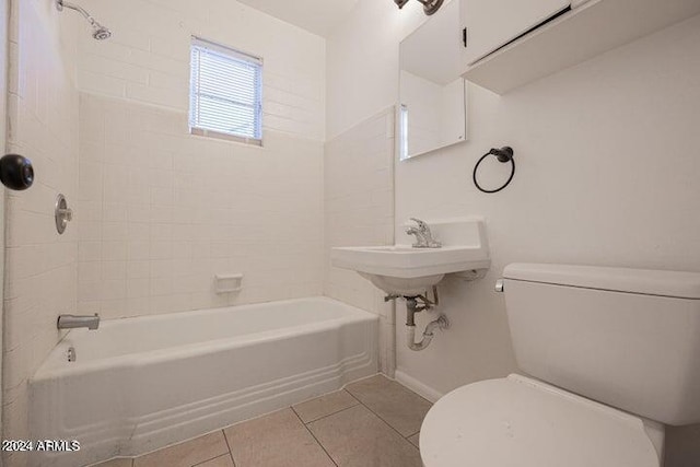 bathroom featuring tiled shower / bath combo, tile flooring, and toilet