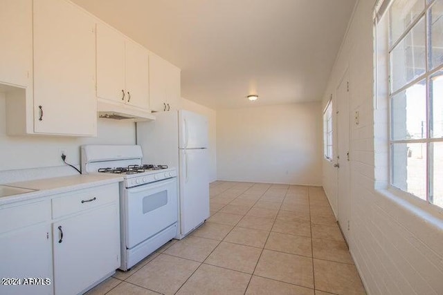 kitchen featuring light tile floors, white cabinetry, and white range with gas cooktop