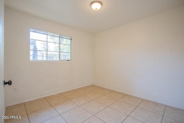 unfurnished room featuring light tile floors