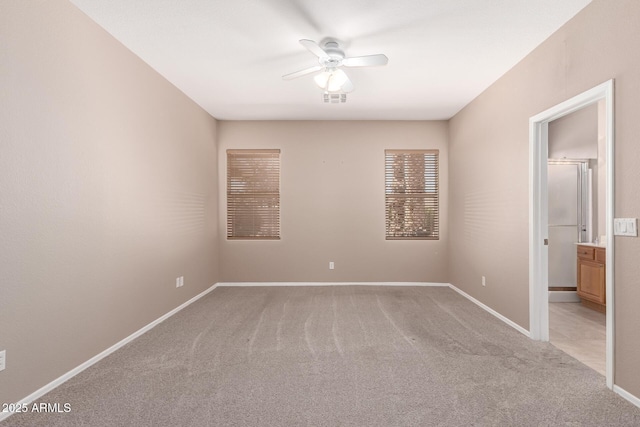 unfurnished room featuring visible vents, baseboards, a ceiling fan, and light colored carpet