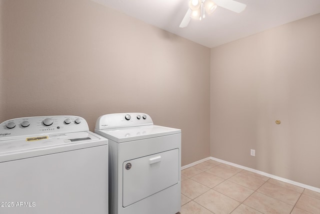 laundry room featuring light tile patterned flooring, laundry area, a ceiling fan, baseboards, and washing machine and clothes dryer