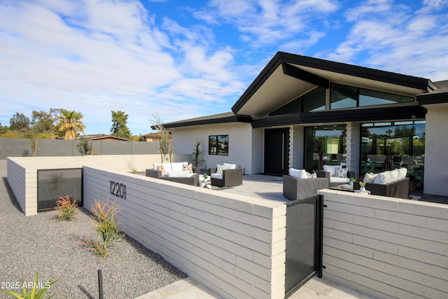 exterior space featuring an outdoor hangout area and a patio