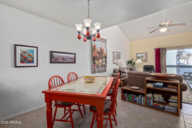 dining room with baseboards, ceiling fan with notable chandelier, vaulted ceiling, and tile patterned floors