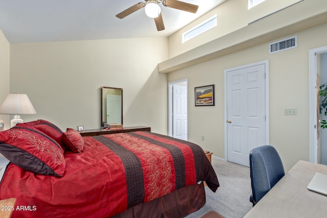 carpeted bedroom with lofted ceiling, visible vents, and a ceiling fan