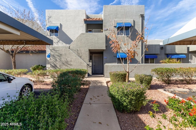 pueblo revival-style home featuring stucco siding