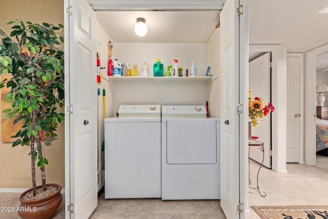 washroom featuring laundry area, independent washer and dryer, and light tile patterned floors