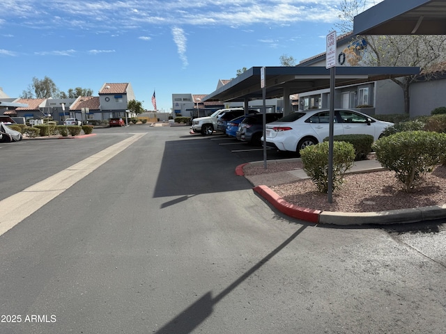 covered parking lot featuring a residential view