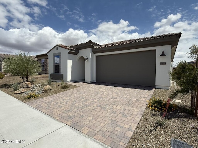 4515 Charro Ct, Wickenburg, AZ 85390 - mediterranean / spanish house with decorative driveway, stucco siding, an attached garage, and a tiled roof