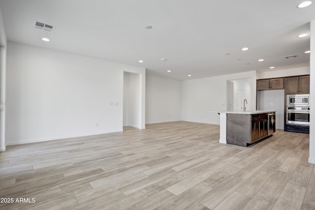 4515 Charro Ct, Wickenburg, AZ 85390 - kitchen with open floor plan, recessed lighting, stainless steel appliances, light countertops, and light wood finished floors