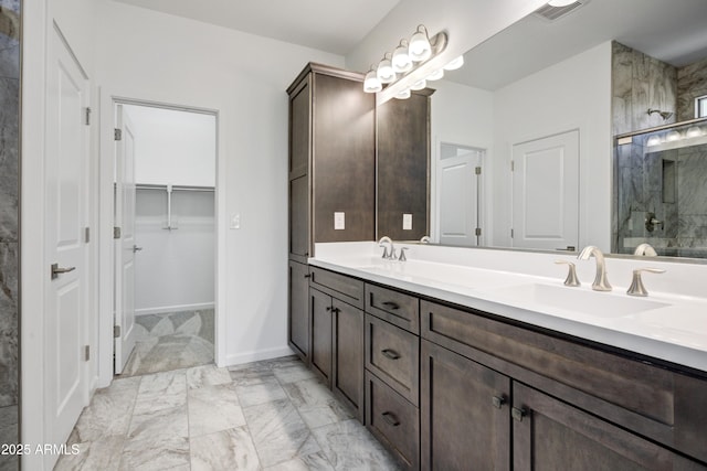 4515 Charro Ct, Wickenburg, AZ 85390 - full bathroom with a stall shower, double vanity, marble look tile flooring, a spacious closet, and baseboards