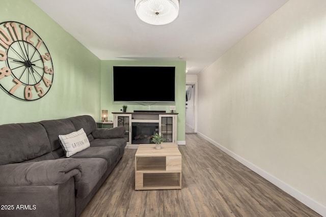 5808 E Lawndale St, Mesa, AZ 85215 - living area with wood finished floors, baseboards, and a glass covered fireplace