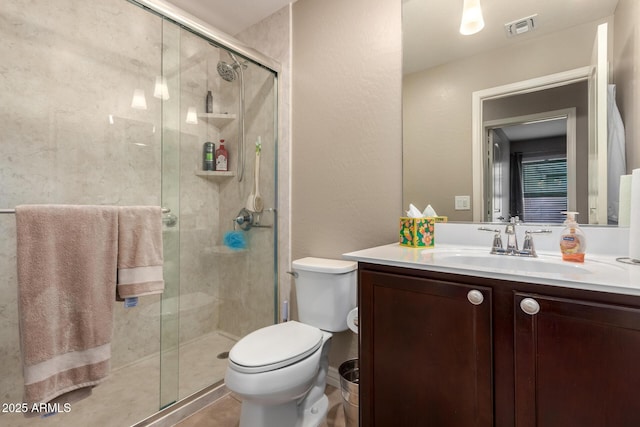 bathroom featuring vanity, toilet, visible vents, and a stall shower