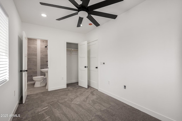 unfurnished bedroom with a closet, recessed lighting, baseboards, ensuite bathroom, and carpet floors