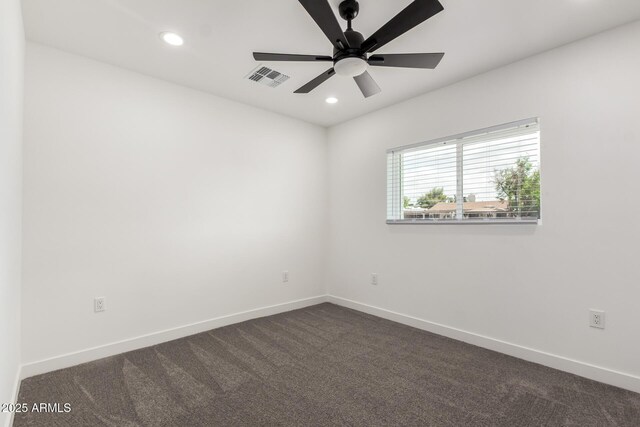 unfurnished room featuring baseboards, dark carpet, recessed lighting, and visible vents