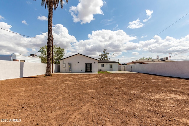 back of house featuring a fenced backyard, a patio area, and stucco siding