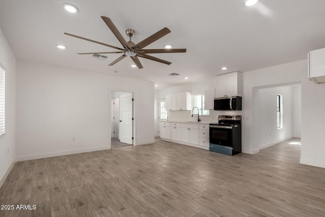 kitchen with a ceiling fan, a sink, electric range, stainless steel microwave, and recessed lighting
