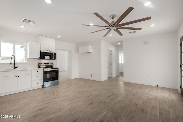 kitchen with a sink, stainless steel appliances, visible vents, a ceiling fan, and white cabinets