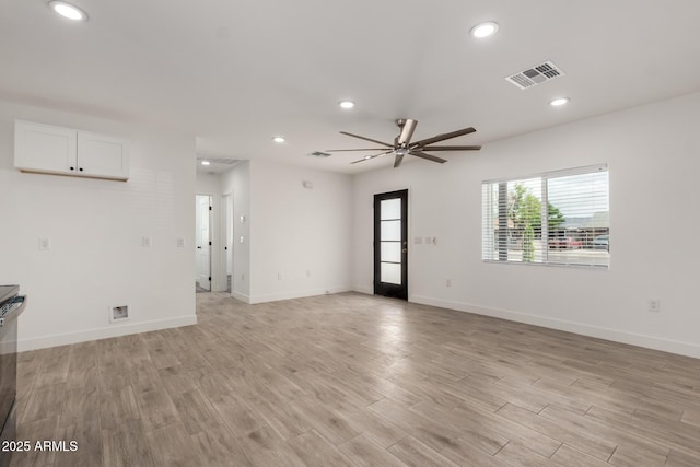 unfurnished living room with visible vents, recessed lighting, light wood finished floors, a ceiling fan, and baseboards