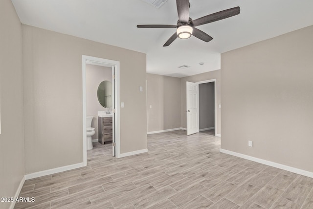 unfurnished bedroom featuring ceiling fan, ensuite bathroom, sink, and light hardwood / wood-style floors