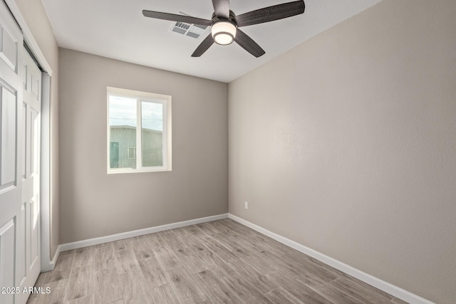 spare room featuring ceiling fan and light hardwood / wood-style flooring