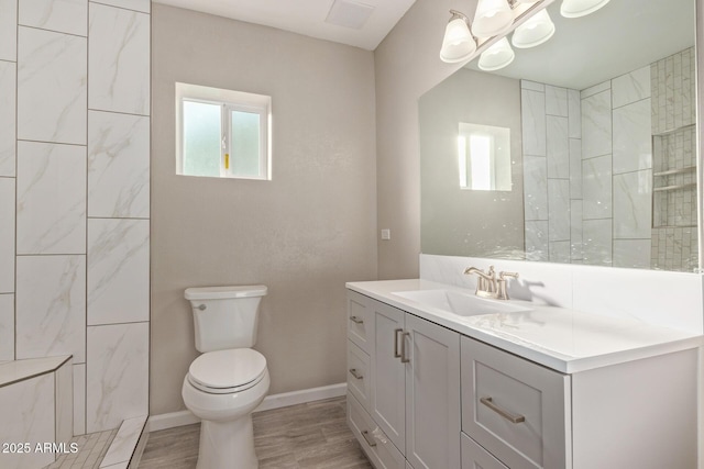 bathroom featuring vanity, hardwood / wood-style floors, and toilet