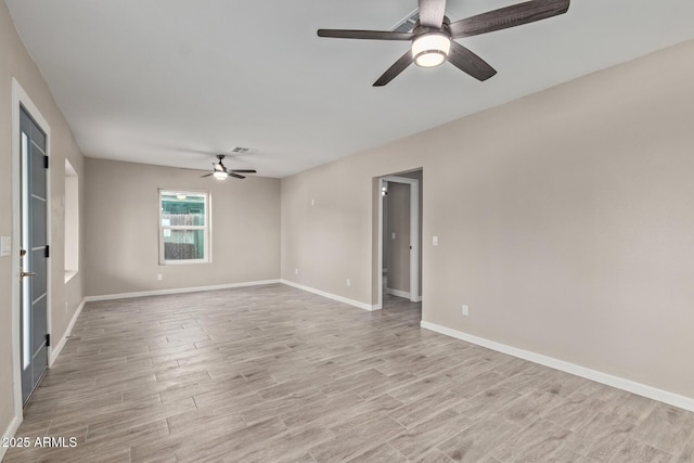 empty room featuring ceiling fan and light hardwood / wood-style floors