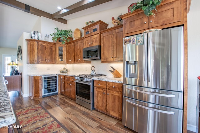3441 N 162nd Ln, Goodyear, AZ 85395 - kitchen featuring stainless steel appliances, wine cooler, beamed ceiling, dark wood finished floors, and brown cabinets
