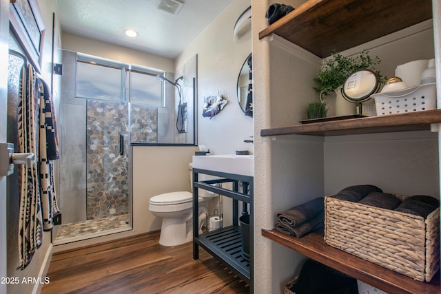 3441 N 162nd Ln, Goodyear, AZ 85395 - full bath with toilet, a shower stall, and wood finished floors
