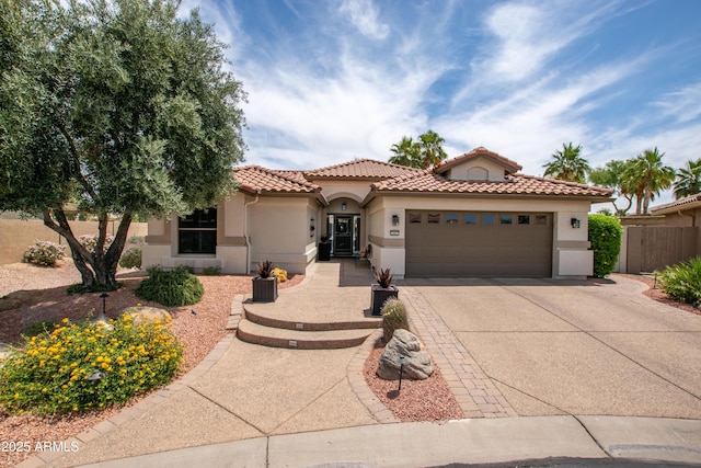 3441 N 162nd Ln, Goodyear, AZ 85395 - mediterranean / spanish-style home with an attached garage, concrete driveway, a tile roof, and stucco siding