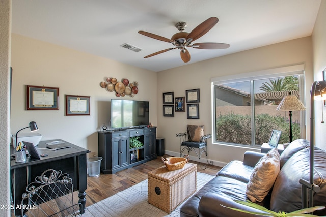 3441 N 162nd Ln, Goodyear, AZ 85395 - living area featuring ceiling fan, light wood finished floors, and baseboards