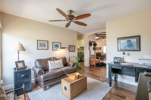 3441 N 162nd Ln, Goodyear, AZ 85395 - living room with ceiling fan, independent washer and dryer, arched walkways, wood finished floors, and baseboards