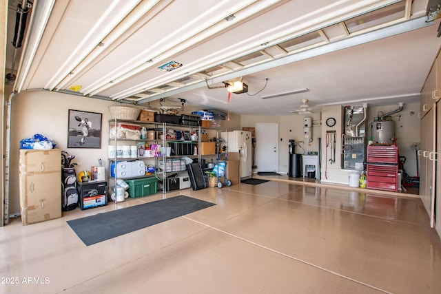 3441 N 162nd Ln, Goodyear, AZ 85395 - garage featuring a garage door opener, a central vacuum unit, and white fridge with ice dispenser