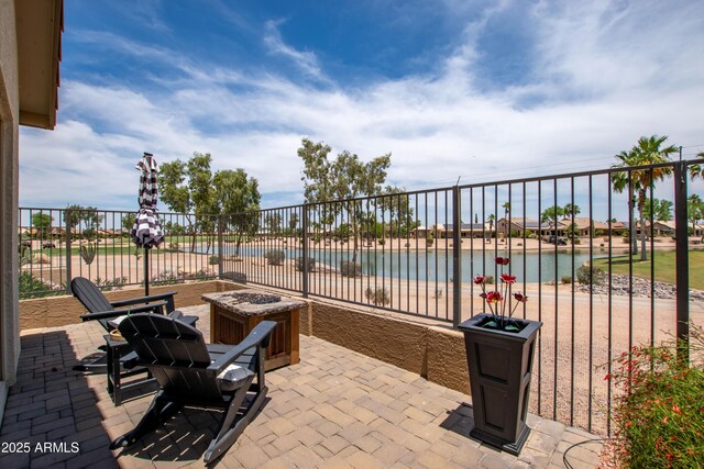 3441 N 162nd Ln, Goodyear, AZ 85395 - view of patio with an outdoor fire pit and a water view