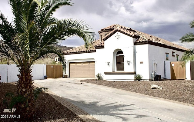 mediterranean / spanish-style home featuring a garage