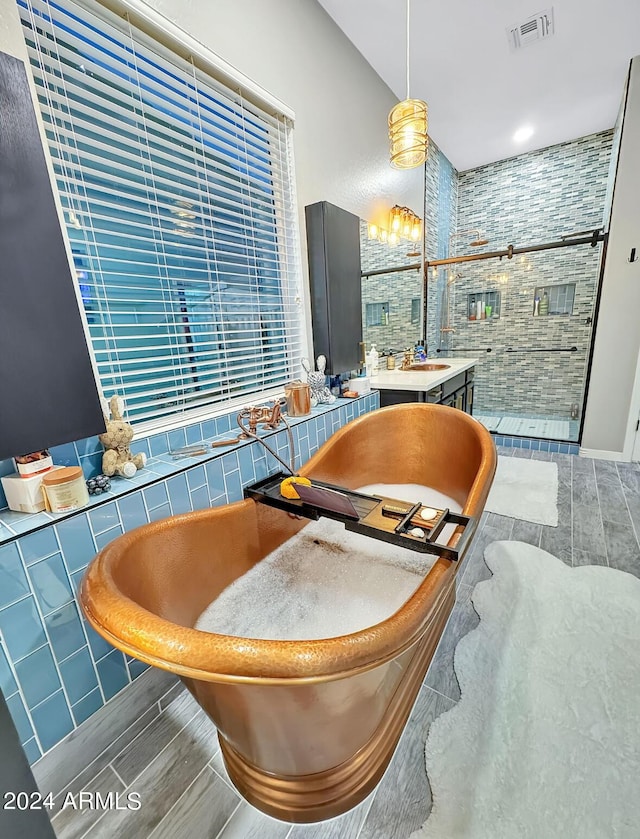 interior space featuring vanity, an enclosed shower, wood-type flooring, and tile walls