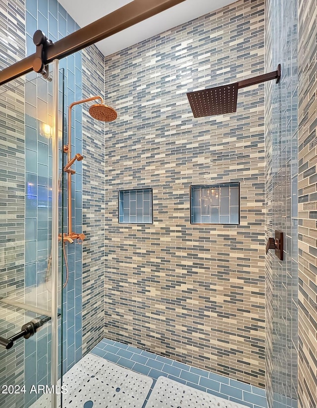 bathroom featuring a shower with shower door