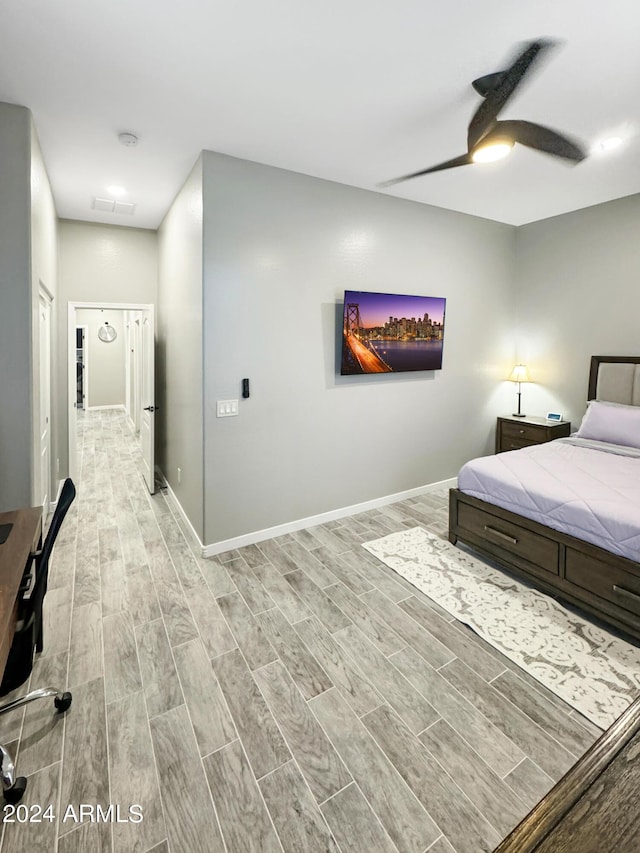 bedroom with light wood-type flooring and ceiling fan