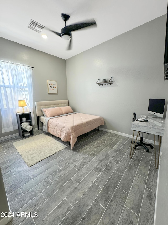 bedroom with hardwood / wood-style flooring and ceiling fan