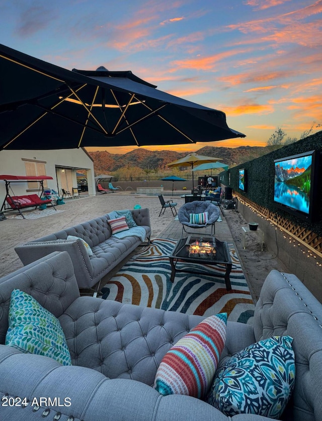 view of patio featuring an outdoor living space with a fire pit