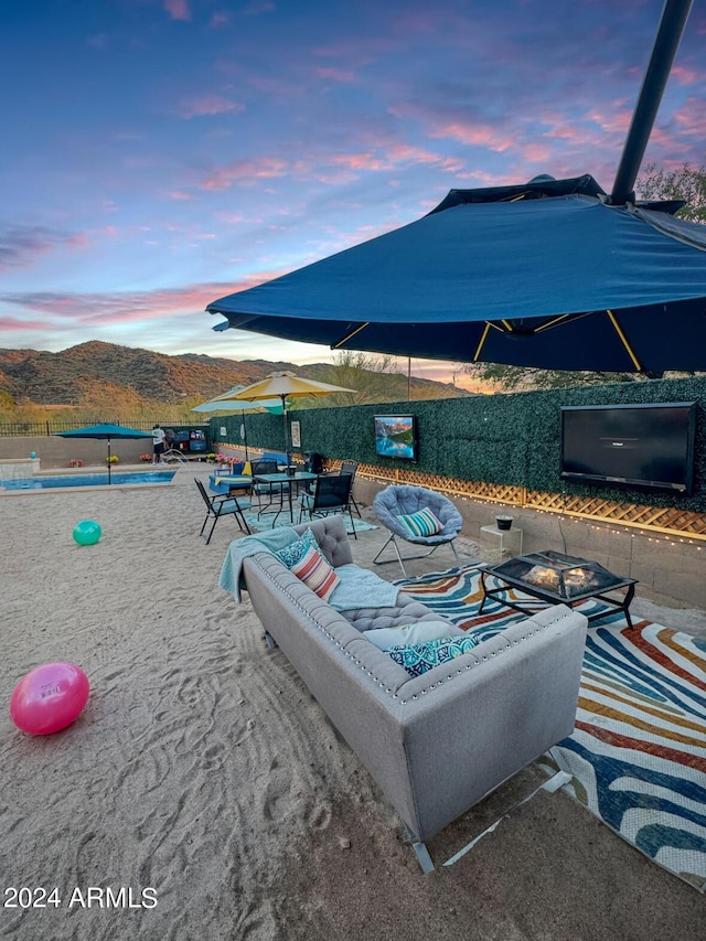 exterior space featuring a mountain view and an outdoor living space