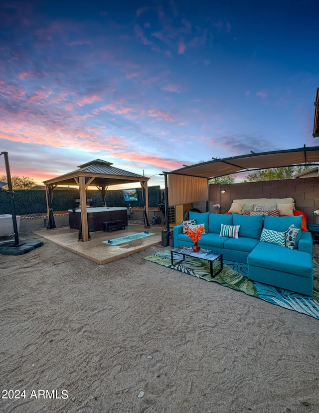 exterior space with a gazebo, outdoor lounge area, and a hot tub