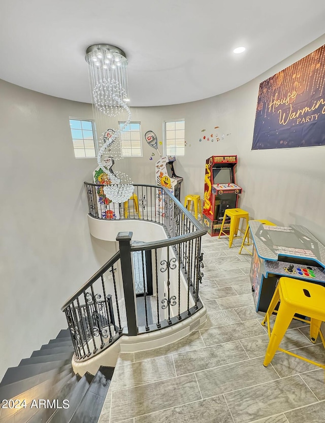 stairs featuring an inviting chandelier