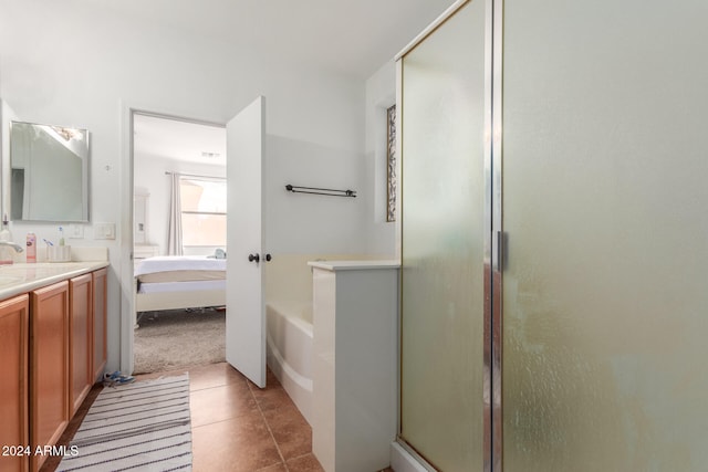 bathroom with vanity, plus walk in shower, and tile patterned flooring