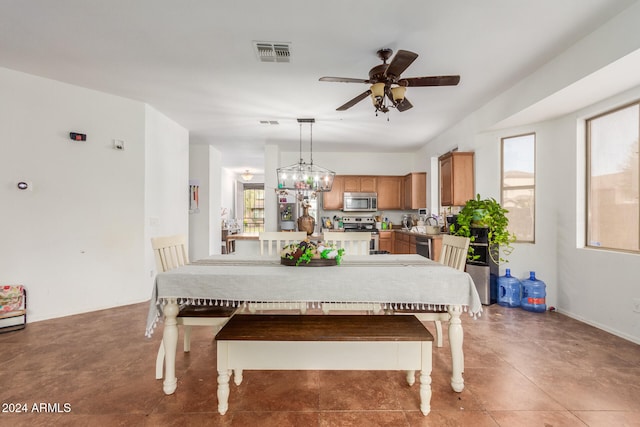 dining room featuring ceiling fan with notable chandelier and sink