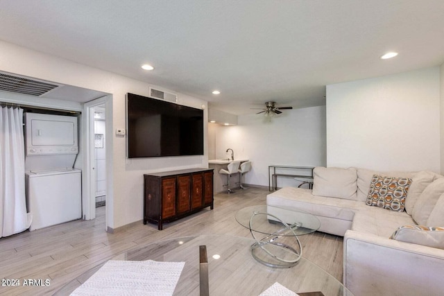 8020 E Thomas Rd Unit 119, Scottsdale, AZ 85251 - living area featuring stacked washer / dryer, light wood finished floors, ceiling fan, and visible vents