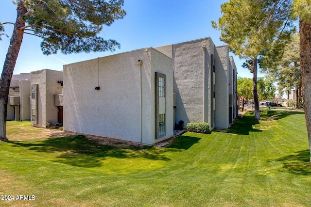 view of home's exterior with a lawn