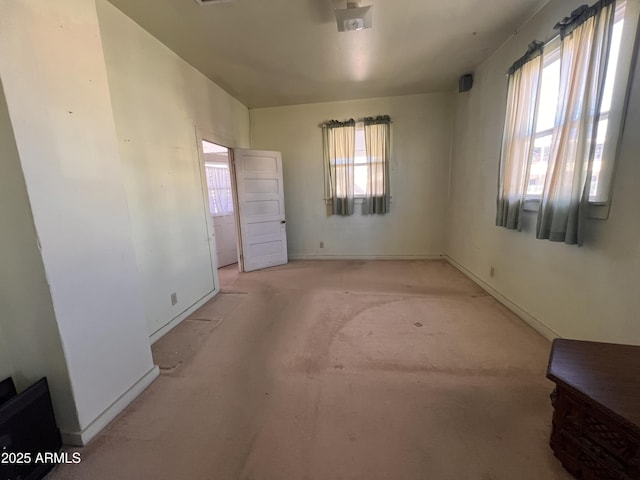 unfurnished room featuring light carpet