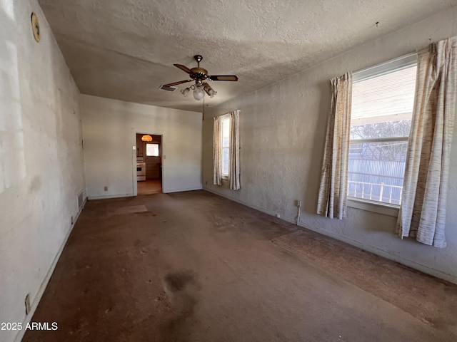 spare room with ceiling fan and a wealth of natural light